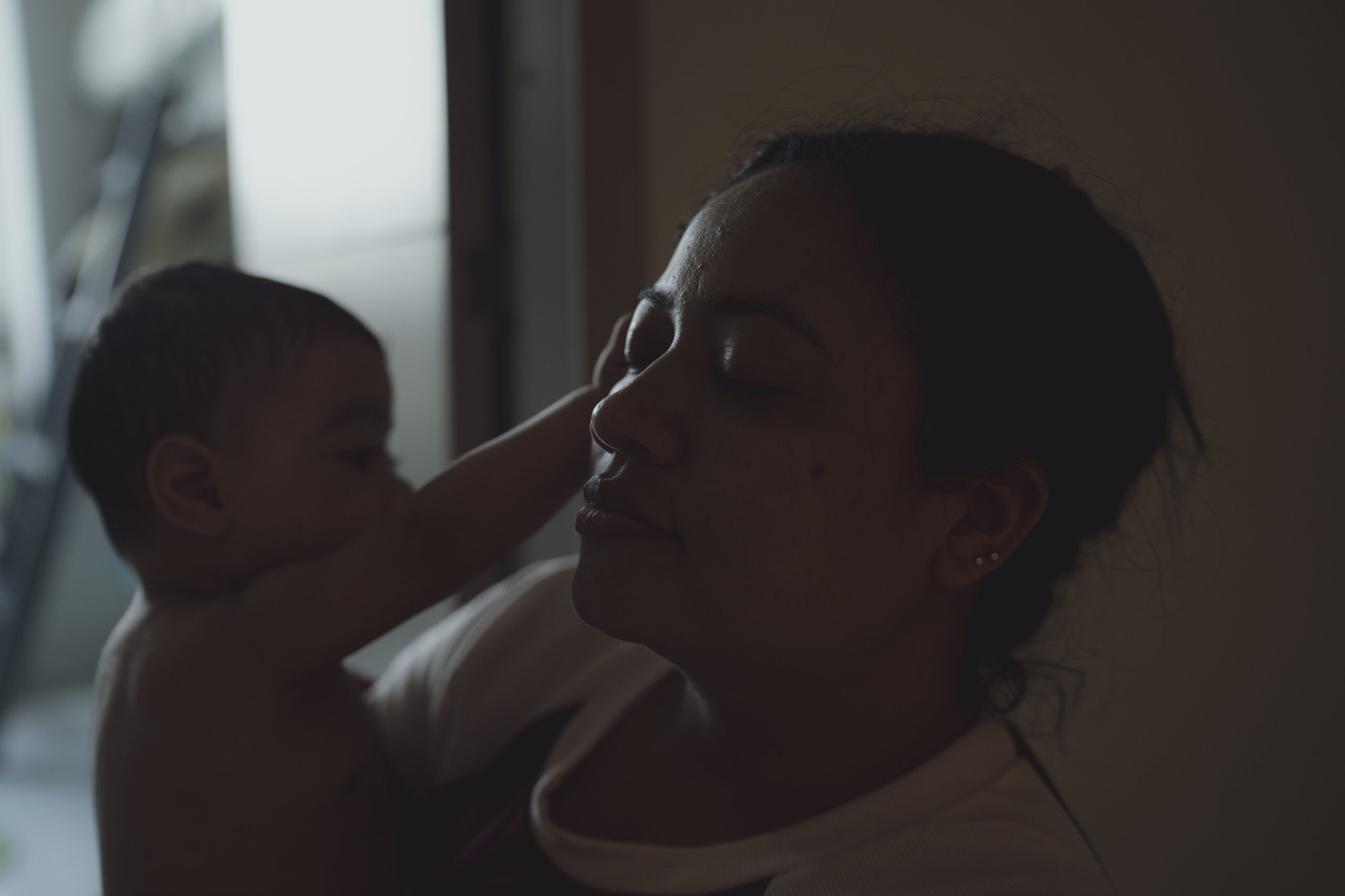 Mom and baby with baby rubbing mom's face