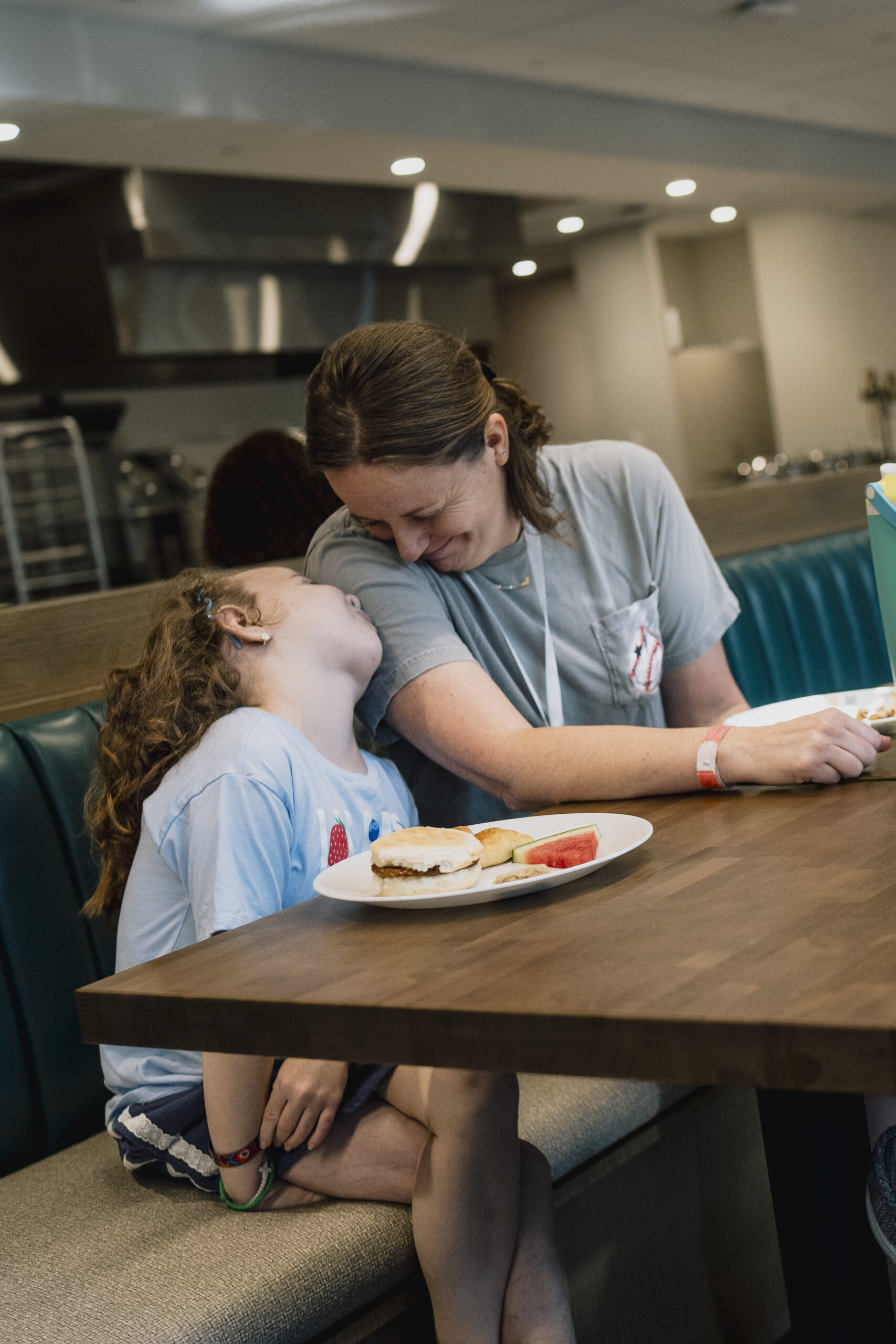 Mom and child in booth looking at each other