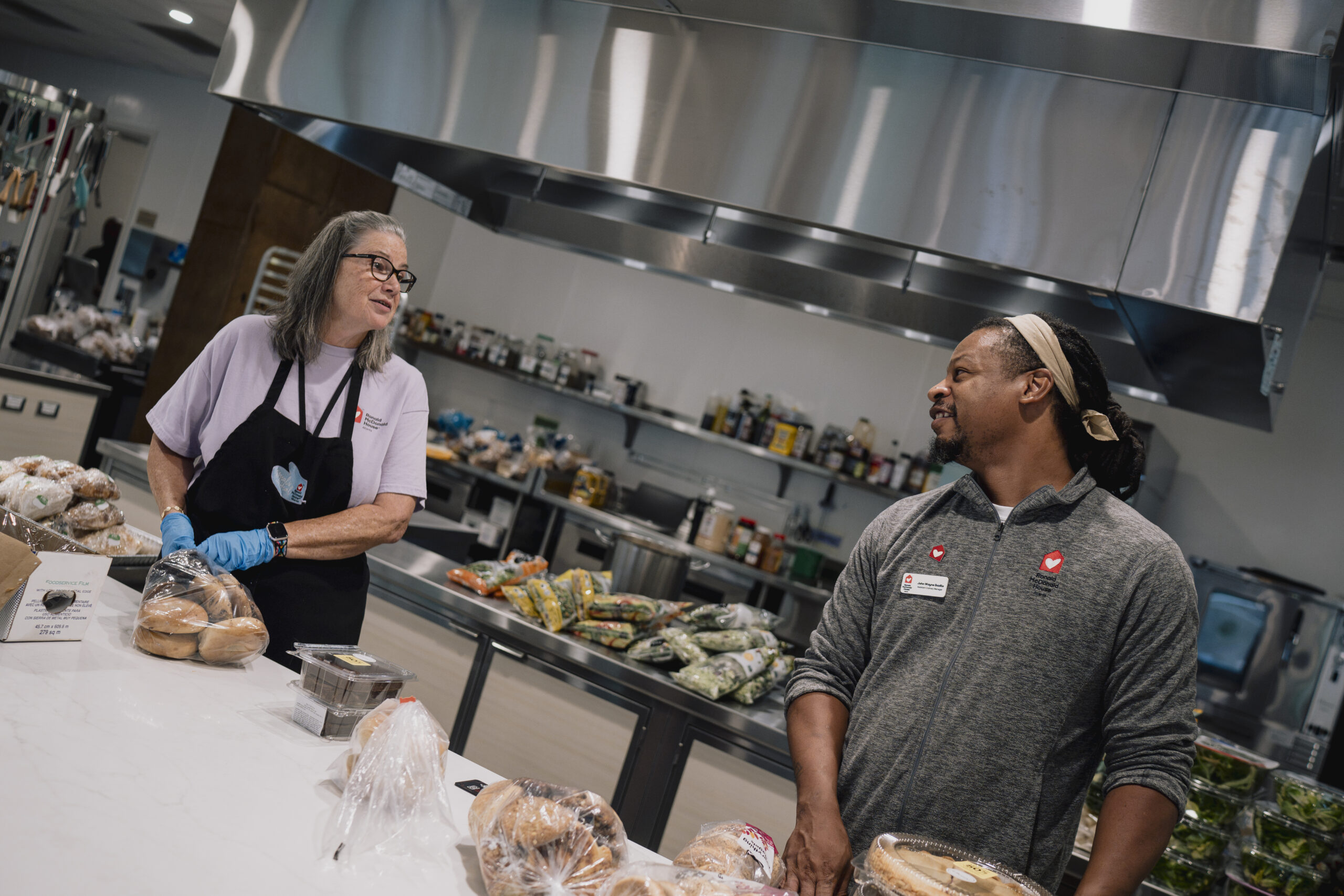 Volunteers preparing a meal for families in the Ronald McDonald House kitchen.